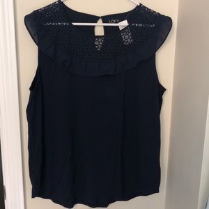 Navy top with detailed neckline.